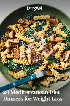 a green plate filled with pasta and mushrooms