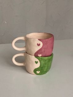 three coffee cups with hearts painted on them