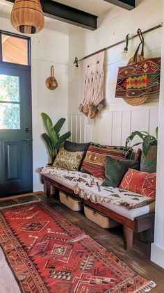 a living room filled with lots of pillows and rugs