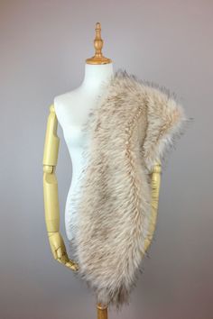 a mannequin wearing a white fur vest