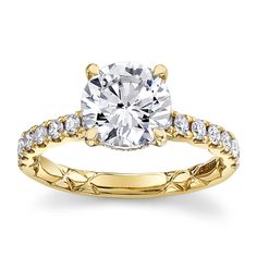 a yellow gold engagement ring with diamonds on it