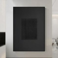 a black and white painting hanging on the wall