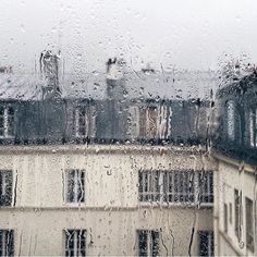 rain is falling on the windows and buildings