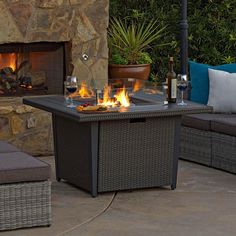 a fire pit sitting next to a couch and table