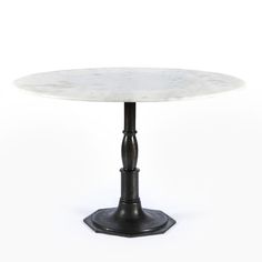 a white marble table with black metal base