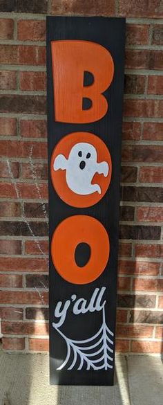 a wooden sign that says boo o'grad with ghost faces and leaves on it