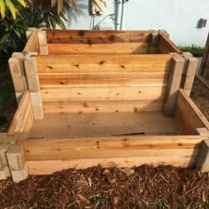 a wooden planter box sitting on top of mulch