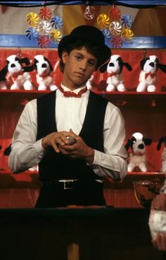 a man standing in front of a shelf with stuffed animals on it's shelves