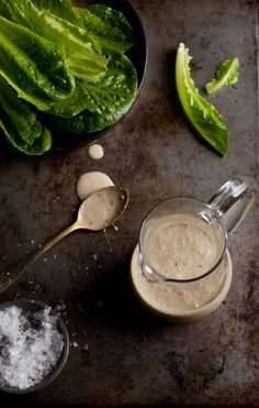 lettuce and other ingredients are on a baking sheet next to a bowl of ice cream