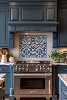 a stove top oven sitting inside of a kitchen next to blue cabinets and counter tops