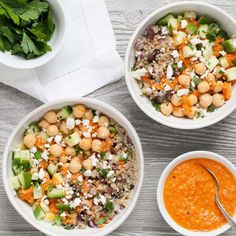 three bowls filled with different types of food next to a napkin and bowl of soup