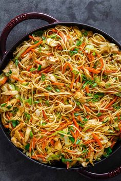 a skillet filled with noodles and vegetables