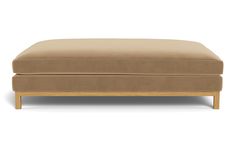 the footstool is made out of wood and has a tan fabric cover on it