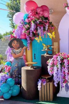 a bunch of balloons and flowers are on display in front of a building with a blue door