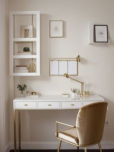 a white desk with gold accents in a home office