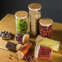 several containers filled with different types of food on a table next to some spices and seasonings