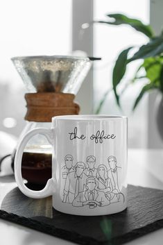 a white coffee mug sitting on top of a table