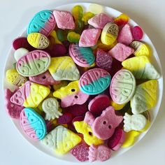 a white plate filled with lots of colorful candies