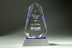 an award is displayed on a silver base with blue glass and metal trimmings