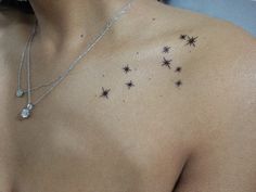 a woman's chest with small stars on it