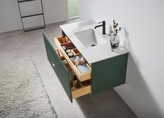 a bathroom with a sink, mirror and drawers in the middle of the floor area