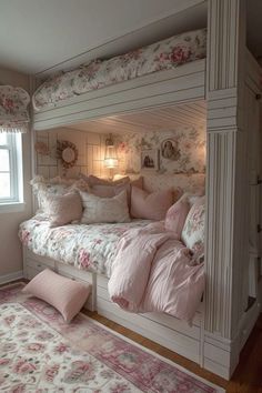 a white bunk bed with pink pillows and blankets on it in a room that has carpeted flooring