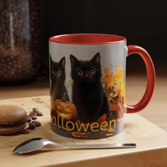 two black cats sitting on top of a table next to a spoon and cup with the words halloween