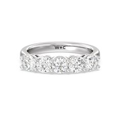 a white gold ring with five stones on the side and two rows of diamonds in the middle