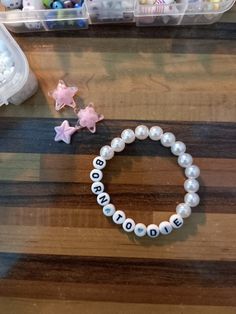 a beaded bracelet with the word mom written on it next to other beads and toys