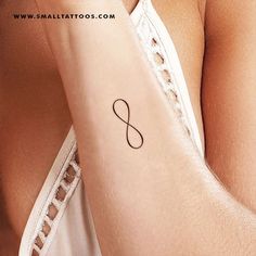 a woman's arm with an infinite symbol tattoo on it