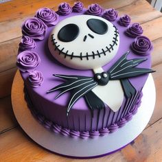 a cake decorated with purple roses and a jack skellingy face