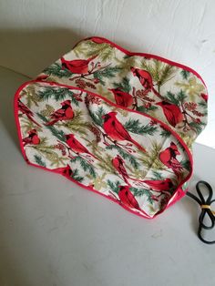 a pair of scissors sitting on top of a table next to a christmas themed tray