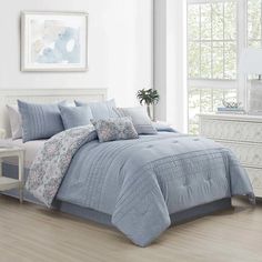 the comforter set is made up in grey and white colors with silver trimmings