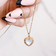 LOVE SHELL NECKLACE: ✦ Small convex heart necklace engraved on both sides and set with white mother of pearl  COMPOSITION: ✦ Gold plated 18K stainless steel ✦ White mother of pearl SIZE: ✦ Pendant: 1.2 x 1.2 cm ✦ Chain lenght: 40 cm + 5 cm extension JEWELLRY CARE: ✦ This jewel is made of stainless steel which makes it tarnish resistant and waterproof. Over time, the golden layer can acquire a slight patina.  In order to keep your jewel as the first day, it is recommended to remove it regularly f Rose Gold Heart Charm Necklace In Stainless Steel, Rose Gold Heart Pendant Necklace In Stainless Steel, Rose Gold Heart Necklace In Stainless Steel, White Stainless Steel Necklaces For Mother's Day, White Metal Heart Necklace For Valentine's Day, White Stainless Steel Heart Pendant Jewelry, Mother's Day White Stainless Steel Necklaces, White Metal Heart Necklace With Heart Charm, White Metal Charm Necklace For Valentine's Day