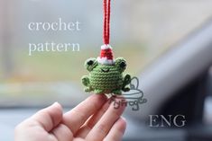 a crocheted frog ornament hanging from a string