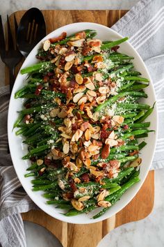 a white plate topped with green beans and almonds