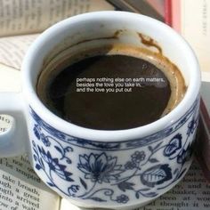 a cup of coffee sitting on top of an open book