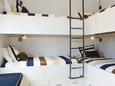 two bunk beds with ladders in a room that has white walls and blue carpeting