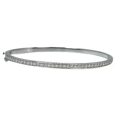 Diamond Bangle bracelet in 14KT white gold. GRAM WEIGHT: 9.42gr METAL: 14KT WHITE gold NATURAL DIAMOND(S) Cut: Round Color: G (average) Clarity: VS-SI (average) Carat: 0.45ct Length: 2.1 inches long by 1.9 inches wide Item number: 170-00008 FKE WHAT YOU GET AT STAMPAR JEWELERS: Stampar Jewelers, located in the heart of Jupiter, Florida, is a custom jewelry store and studio dedicated to providing 100% satisfaction to each client. Our personal attention to detail, passion, affordability and honest Classic White Bracelet With Pave Setting, Dazzling Diamond Bangle Bracelet With Pave Setting, White Diamond Pave Bangle Bracelet, White Classic Bracelet With Pave Setting, White Diamond Bangle Bracelet With Pave Setting, Classic Pave Setting Tennis Bracelet, Classic Platinum Bracelets With Pave Setting, Classic Channel Set Diamond Bracelet, Formal Diamond White Channel Set Bracelet