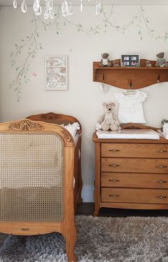 a baby's room with two cribs and a dresser