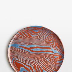 an orange and blue plate sitting on top of a table