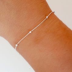 Minimalist style bracelete with inserted balls, made of Sterling Silver.  This is a very simple and elegant women's bracelet, made of 925 Sterling Silver, ideal for day to day.  This bracelet is ideal to put it on and not take it off. It fits very tight on the wrist, usually without being too tight.  It's 16cm long and doesn't have an extension, so it's a good idea to measure your wrist to make sure it fits perfectly. Would you like to have the version of this bracelet in silver with gold platin Minimalist Sterling Silver Satellite Chain Bracelet, Silver Minimalist Satellite Chain Bracelet, Minimalist Silver Satellite Chain Bracelet, Dainty Sterling Silver Bracelet With Satellite Chain, Sterling Silver Bracelets With Satellite Chain, Eco Friendly Stores, Women In India, 925 Silver Bracelet, Ball Bracelet