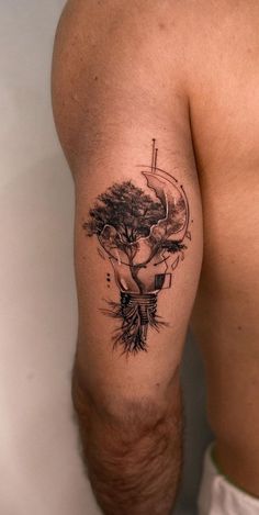 a man with a tree tattoo on his arm