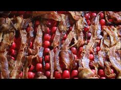 the meat is being cooked on the grill with cranberries and other food items