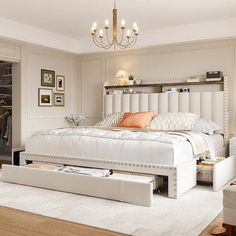 a bedroom with a white bed and lots of storage underneath the headboard is shown