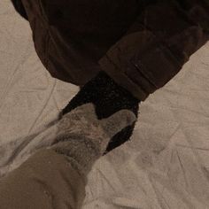 the person is wearing socks and walking on snow