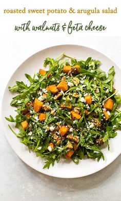 a white plate topped with greens and sweet potato salad