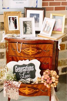 an old dresser is decorated with pictures and other items for wedding guests to take home