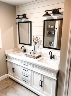 a bathroom with two sinks and mirrors in it