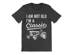 Celebrate timeless style with our I'm Not Old, I'm A Classic Tractor Shirt! Perfect for any tractor enthusiast or farmer, this shirt combines humor with a love for the land. Made from soft, durable fabric, it's ideal for everyday wear on the farm or out and about. If you're looking for unique farmer gifts for men, this tractor shirt makes a great choice. Whether it's for a birthday, Father's Day, or just because, it's a perfect way to show pride in being a classic! I'm Not Old I'm A Classic 'Tra Funny Tractor Quotes, Farm Dad Shirts, Funny Farmer Shirts, Tractor T Shirt, John Deere Cute Shirts, Funny Fathers Day Gifts, Classic Tractor, Gifts For Farmers, Funny Fathers Day